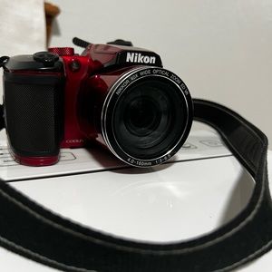 Red Nikon camera, battery powered